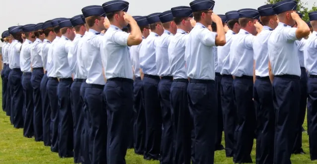 stock image of ROTC students saluting