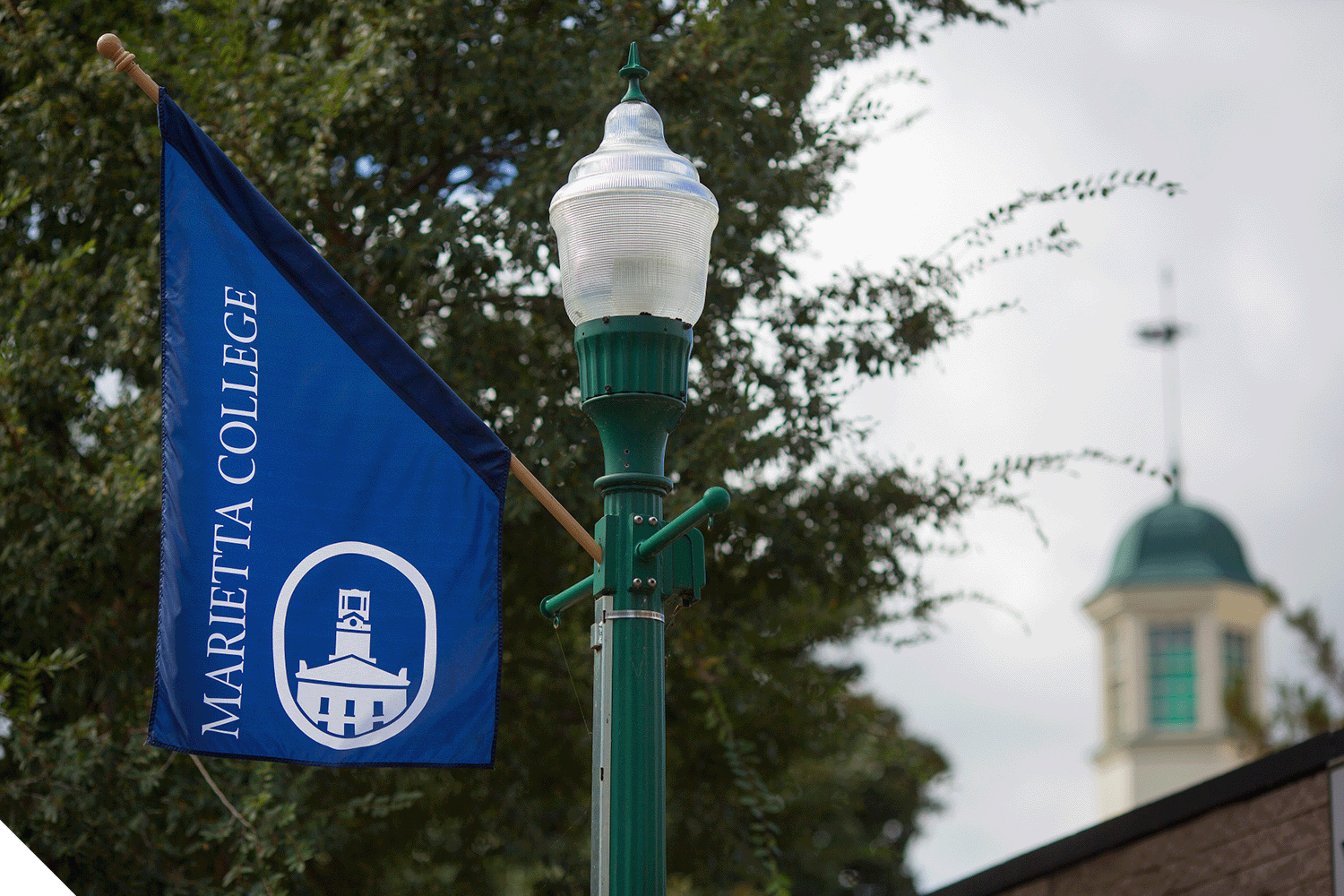 A Marietta College flag on a street light post