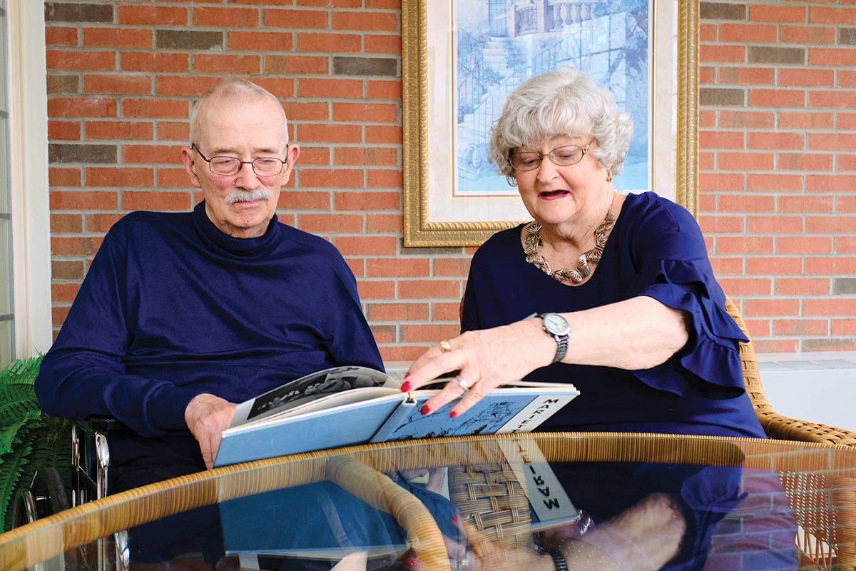 Carl and Judy Heinrichs look at a Marietta College yearbook together