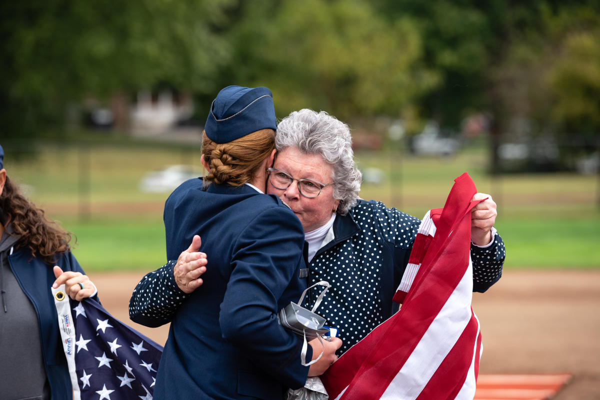 Brittany Curry '15 hugs Jeanne Arbuckle after her promotion ceremony on the Marietta Softball Field