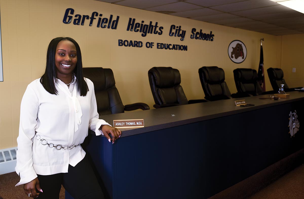 Ashley Thomas poses in front of the Garfield Heights City Schools Board of Education Sign