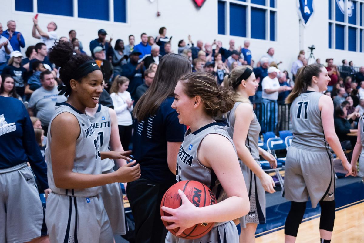 Womens Basketball Players celebrate after a win
