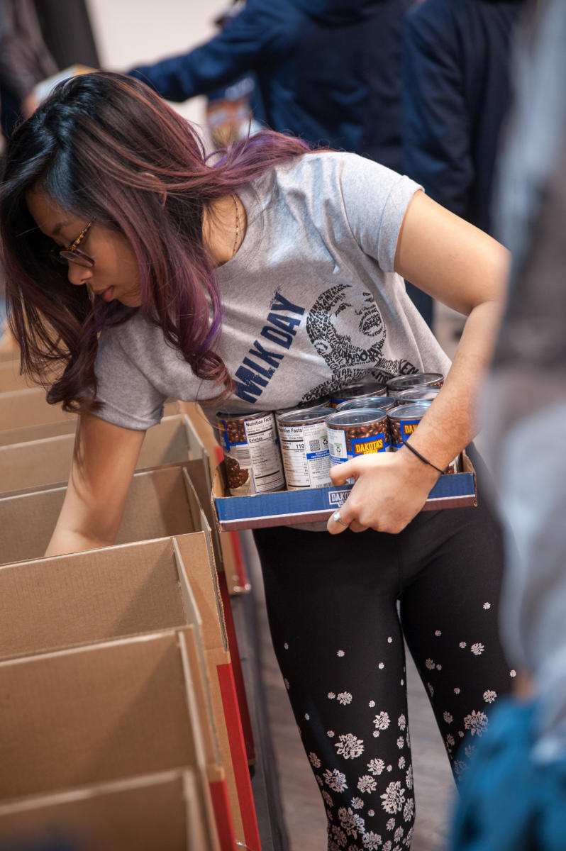 A Marietta College student fills boxes with canned goods for the 2019 Day of Service