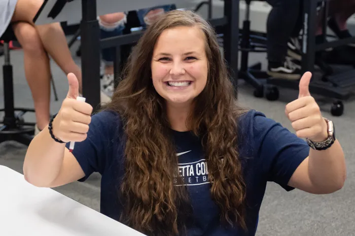 Female student giving thumbs up