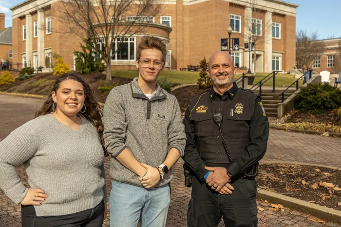 Jaden Koren, Colin Walters and Chief Jim Weaver pose for a photo on the Christy Mall