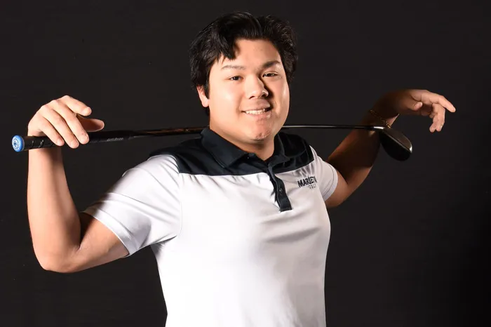 Male golfer with club on shoulders