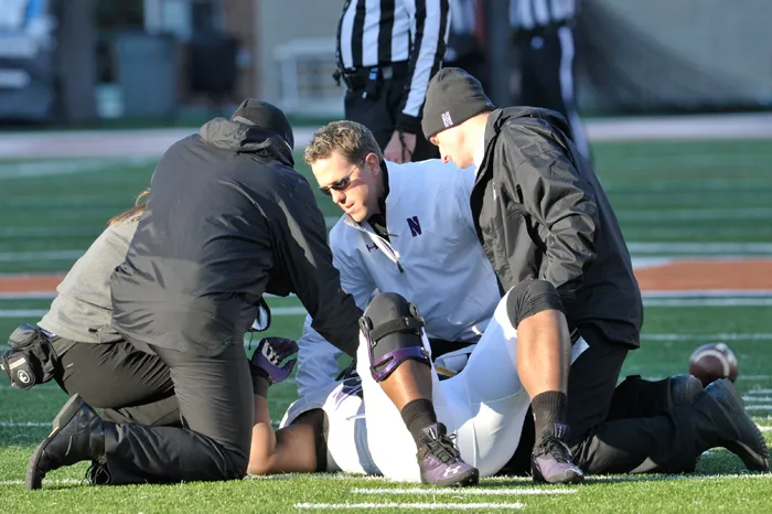 Northwestern's Tory Lindley assisting an injured football player