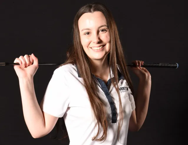 Female golfer with a club over her shoulders