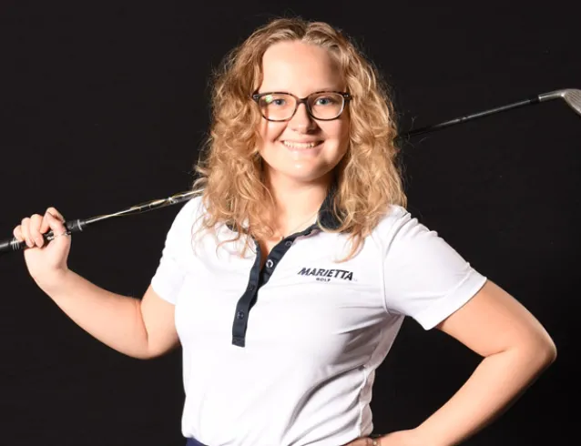 Female golfer with a club over one shoulder