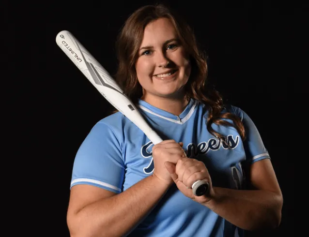 Softball player with bat on shoulder