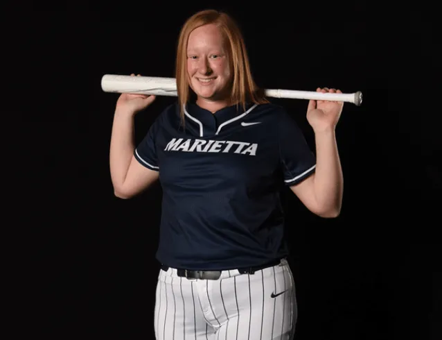 Softball player with bat over shoulders