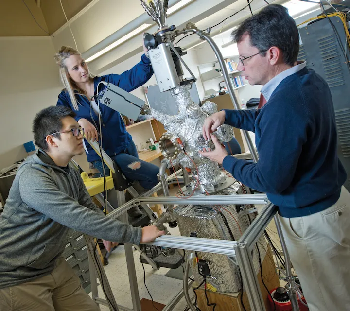 Marietta College Physics Majors work on a project with their professor