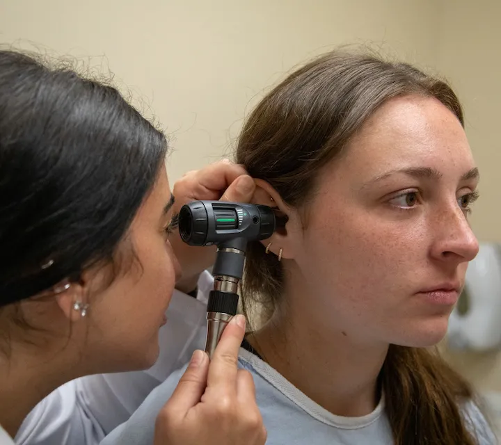 A Marietta College Physician Assistant Studies graduate student examines another student