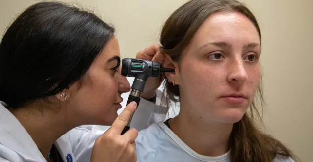 PA student examing a patient