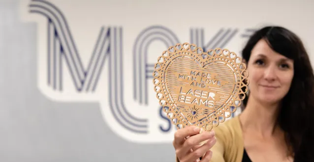 Sara Rosenstock holding an item created with a 3-D laser printer