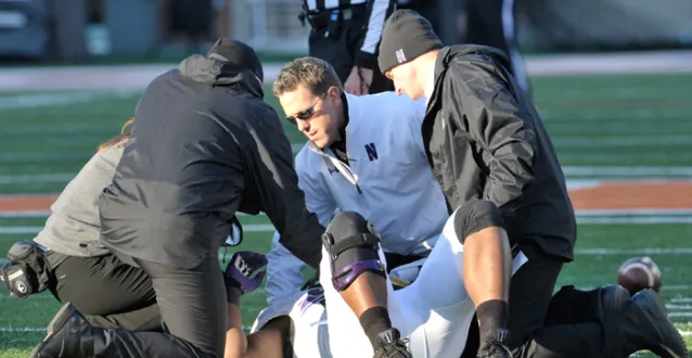Northwestern's Tory Lindley assisting an injured football player