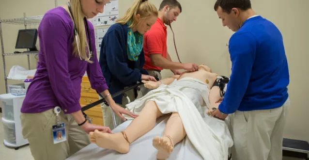 PA students practicing on a dummy
