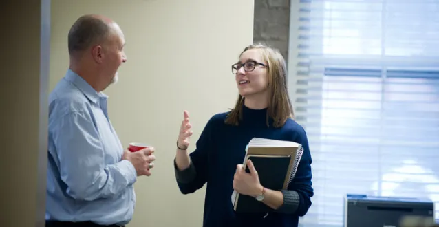 Professor Mark Sibicky speaking with a student