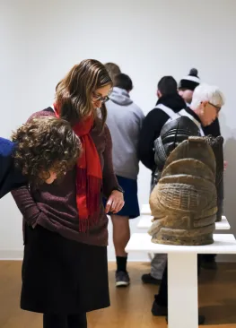 People viewing artifacts on display during "Rites and Passages: Selected Artifacts from the Marietta College African Art Collection"