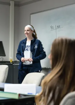 A Marietta College leadership student stands at a whiteboard