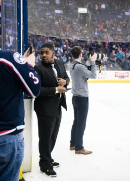 A Marietta College Sport Management major works during a Columbus Blue Jackets game as part of a job shadow.