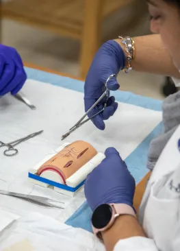 A Marietta College PA student performs a suture