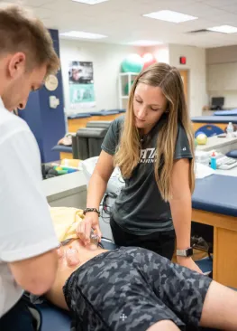 A Marietta College Master of Athletic Training student works on an athlete