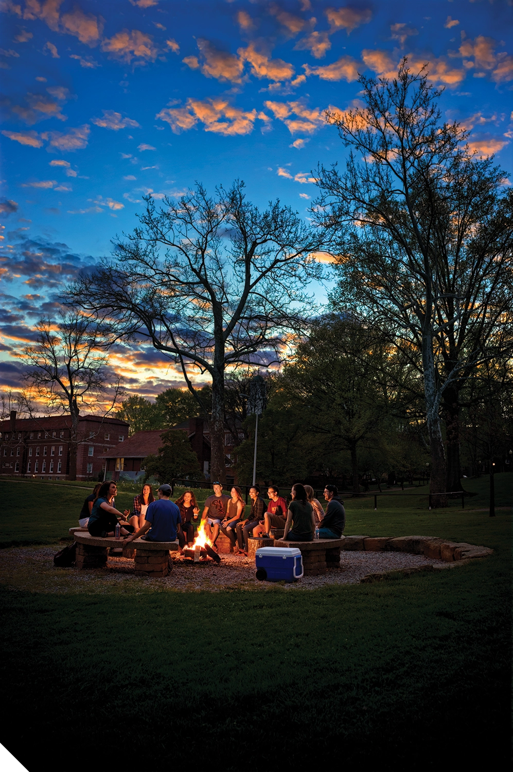 Marietta College students sitting around a campfire