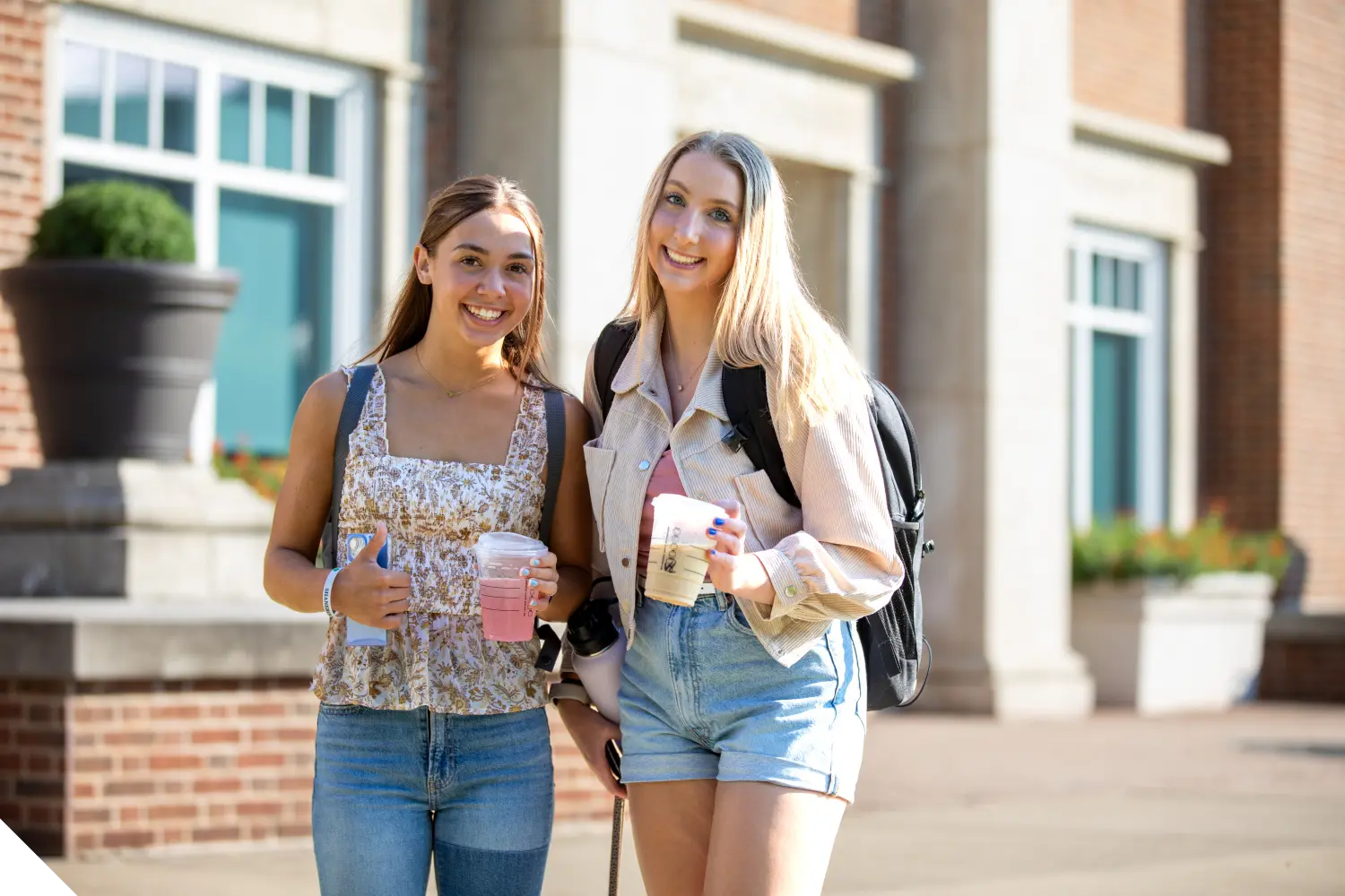 Two Marietta College student pose in front of the Legacy Library