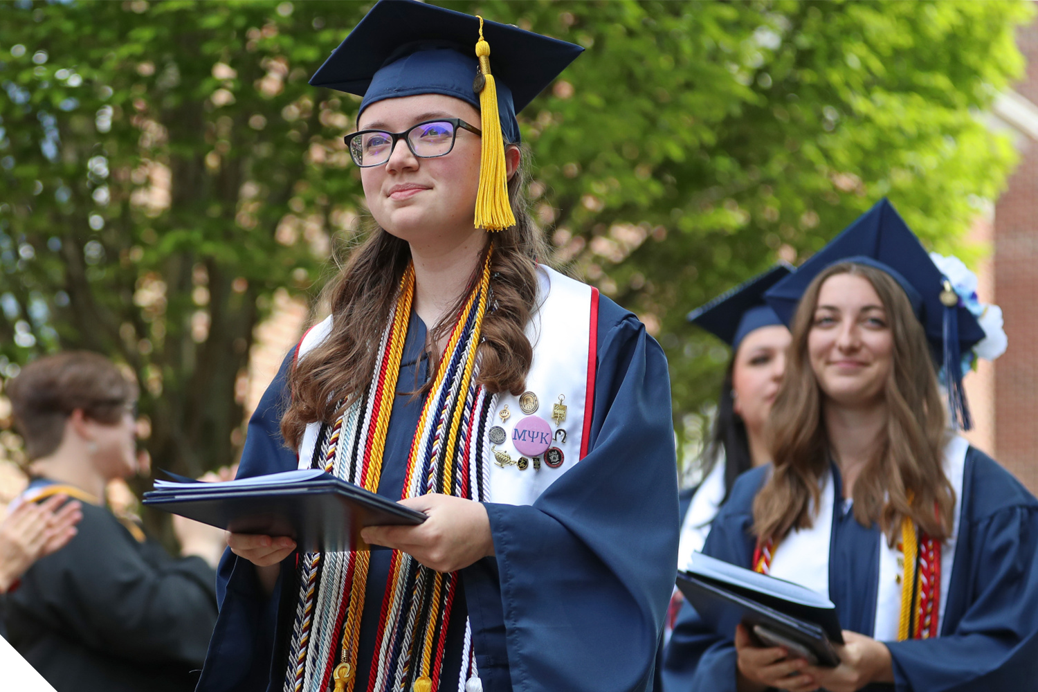 A Marietta College graduate walks in the post-commencement ceremony procession