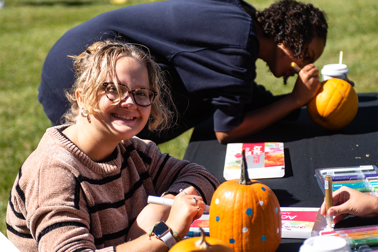 A Marietta College Student decorates a pumpkin during a Student Life Event