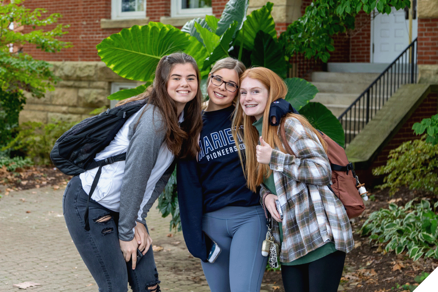 Three Marietta College students pose for a photo outside of Andrews Hall