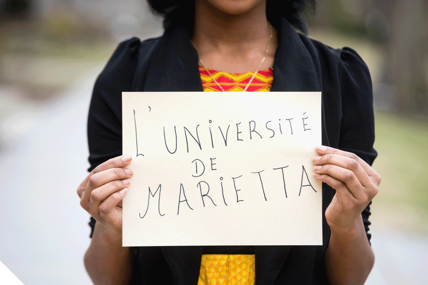 A Marietta College student holding a sign