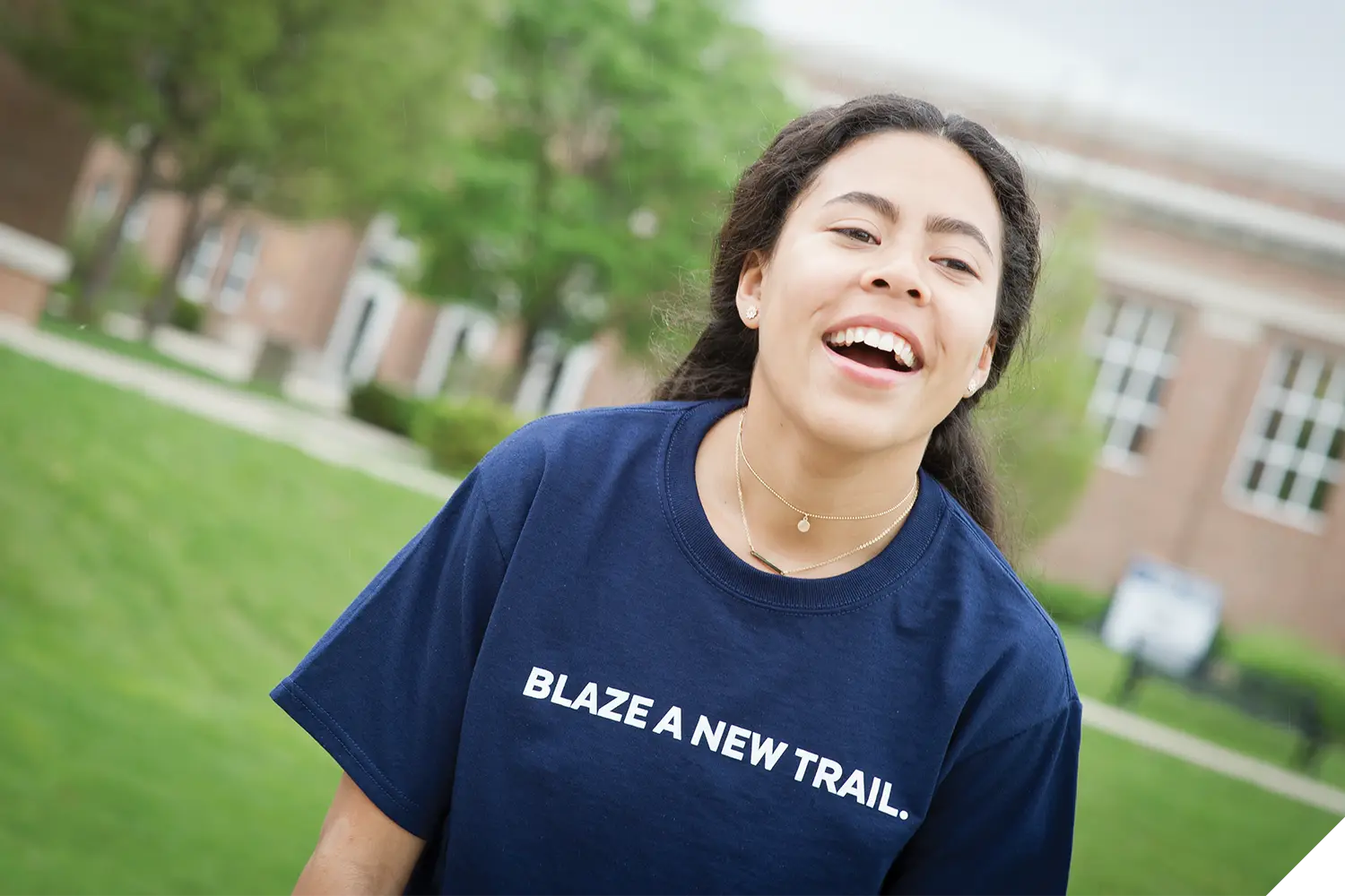 A Marietta College student wearing a shirt that reads "BLAZE A NEW TRAIL."