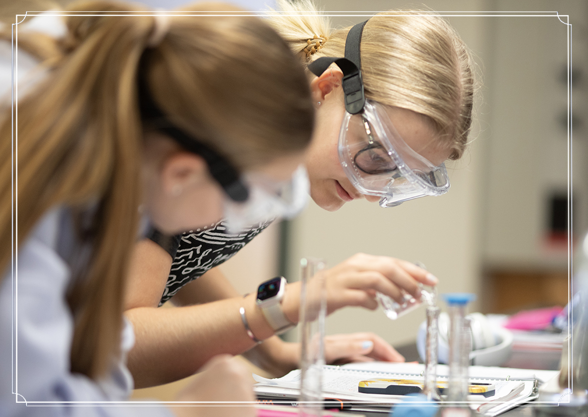 Two students with goggle in chemistry lab