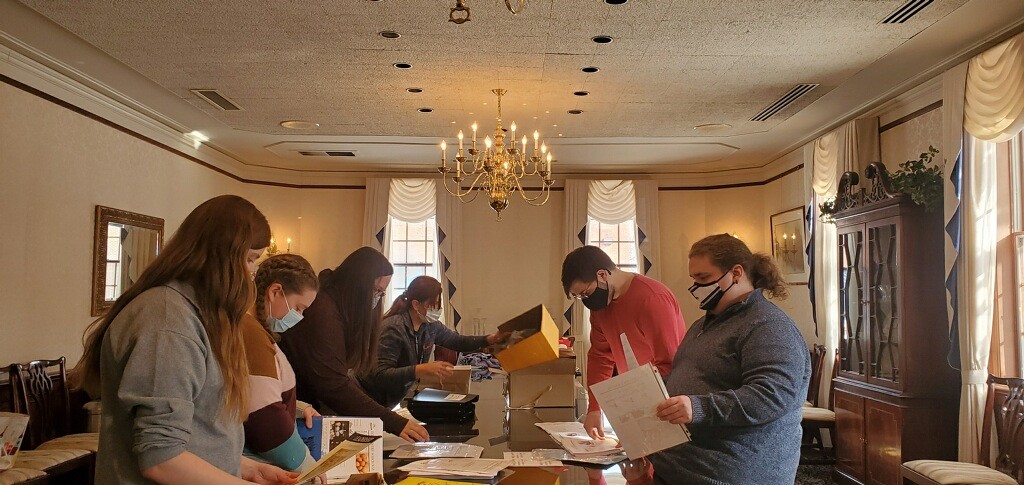 Marietta College NSLS members filling boxes with food for a service project