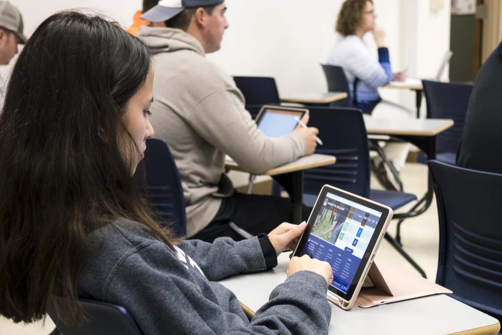 Marietta College student with iPad in class