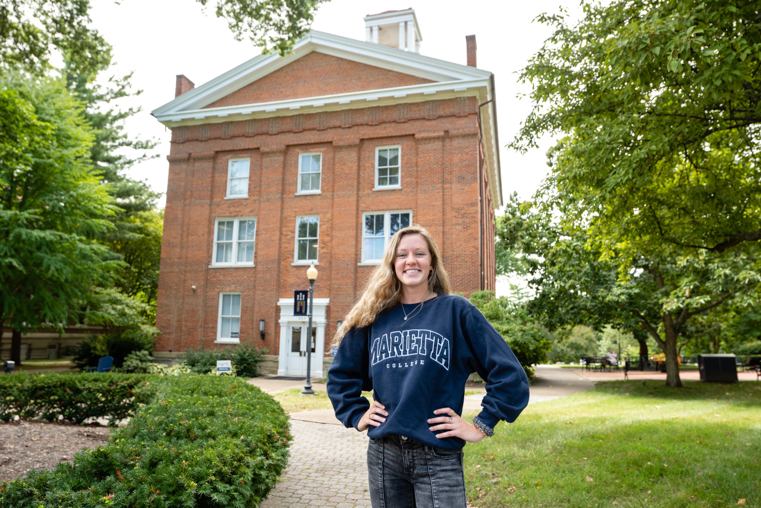 A Marietta College student poses in front of Erwin Tower