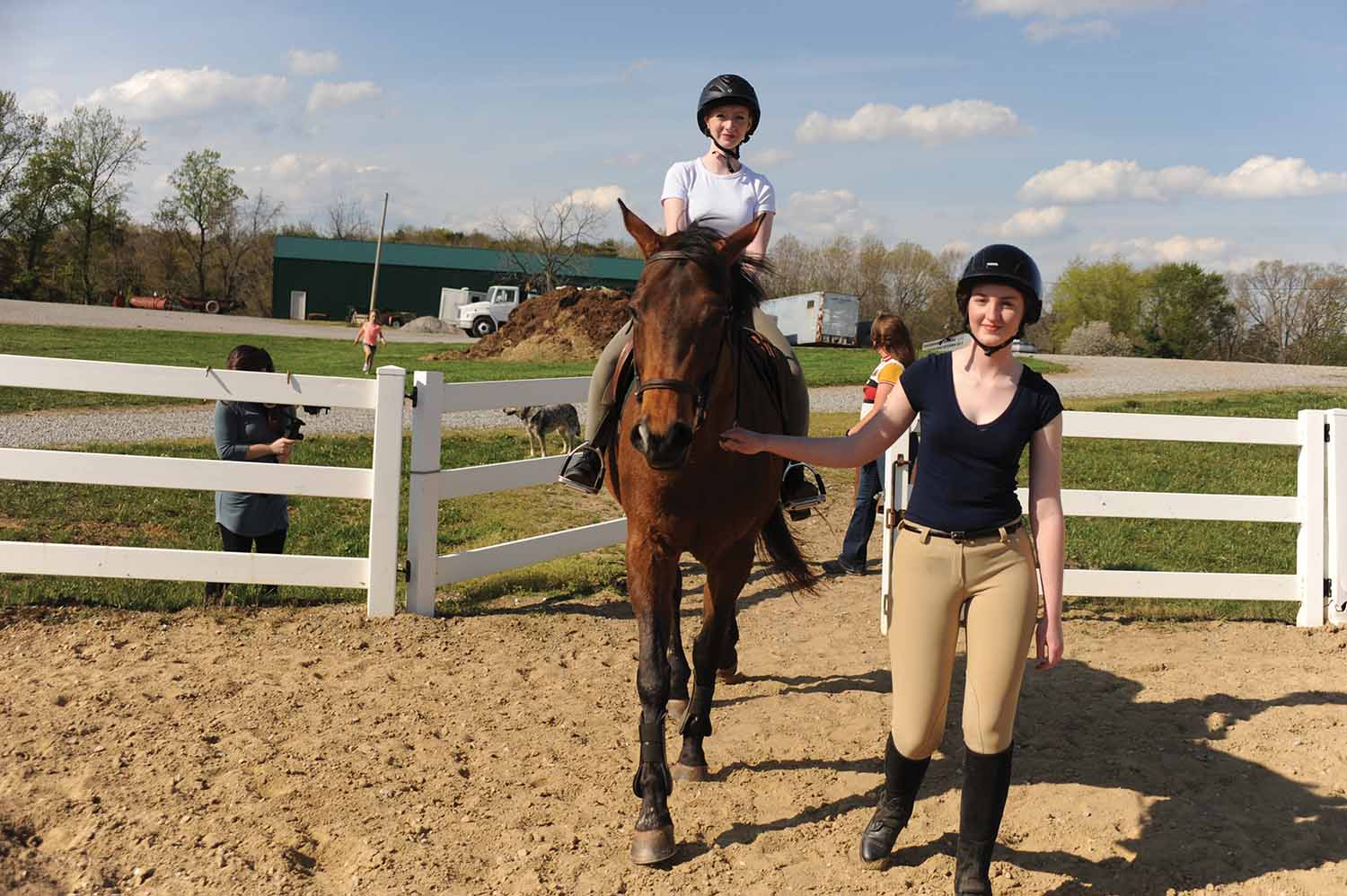 Kayla Clark '22 and Julie Schanz '23 lead a horse