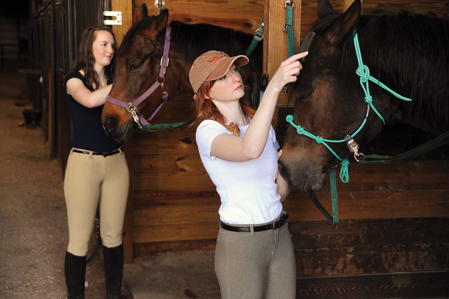 Kayla Clark and Julie Schlanz tend to their horses after their ride