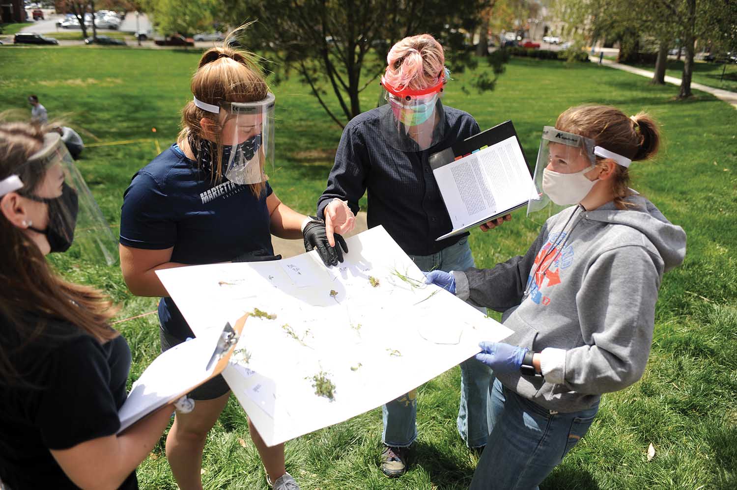 Catherine Wadih â22 helps students identify plant species during a Biology 106 lab. Wadih, a Biology and Math major, completed a tutorship during spring semester with Biology Professor Katy Lustofin