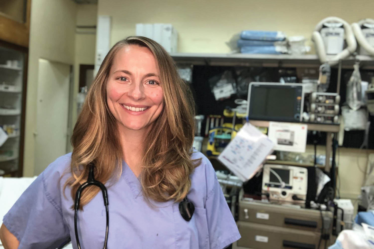 A portrait of Marietta College 2009 Physician Assistant Graduate Lindy Nester who stand in front of equipment