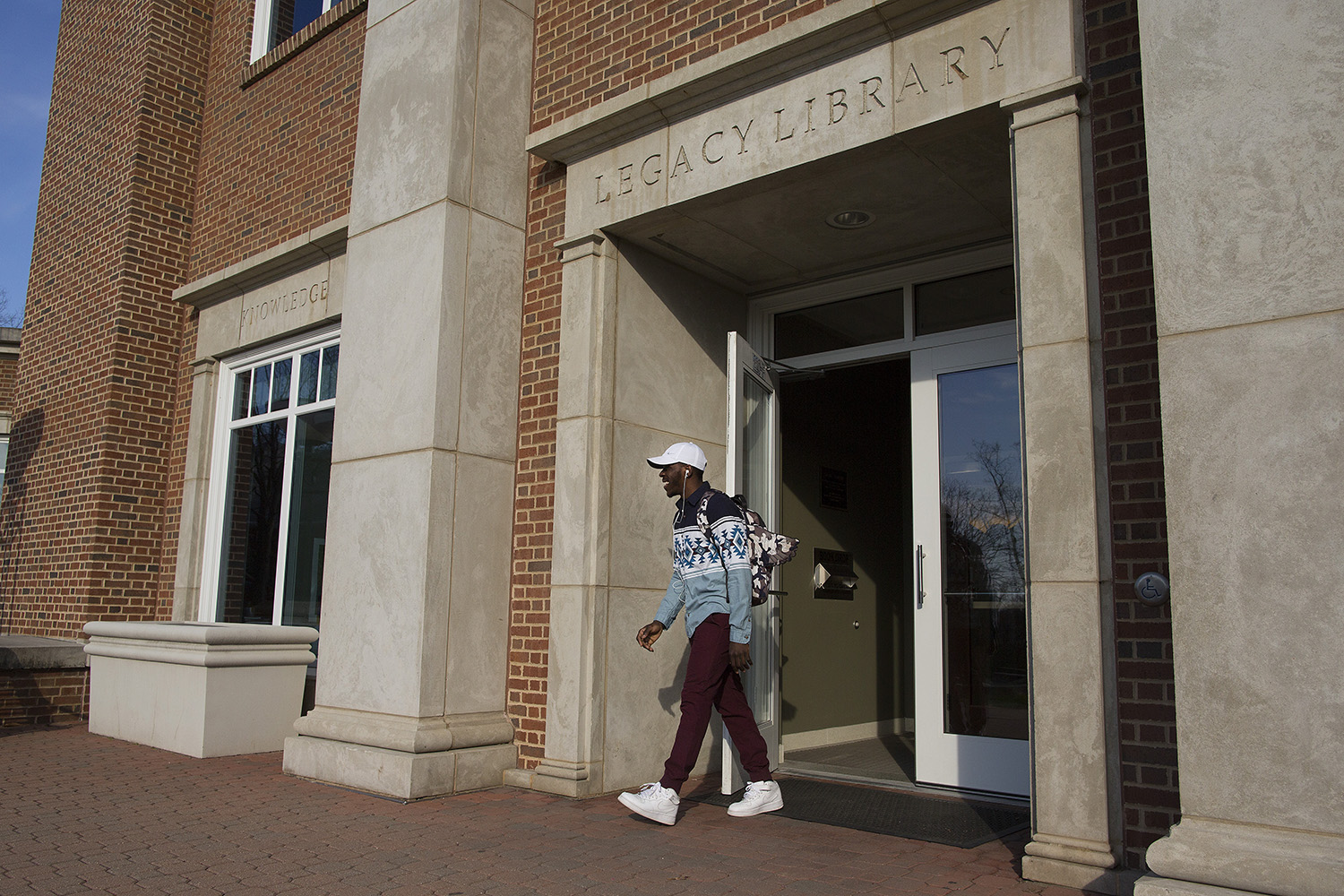 student walks out of library