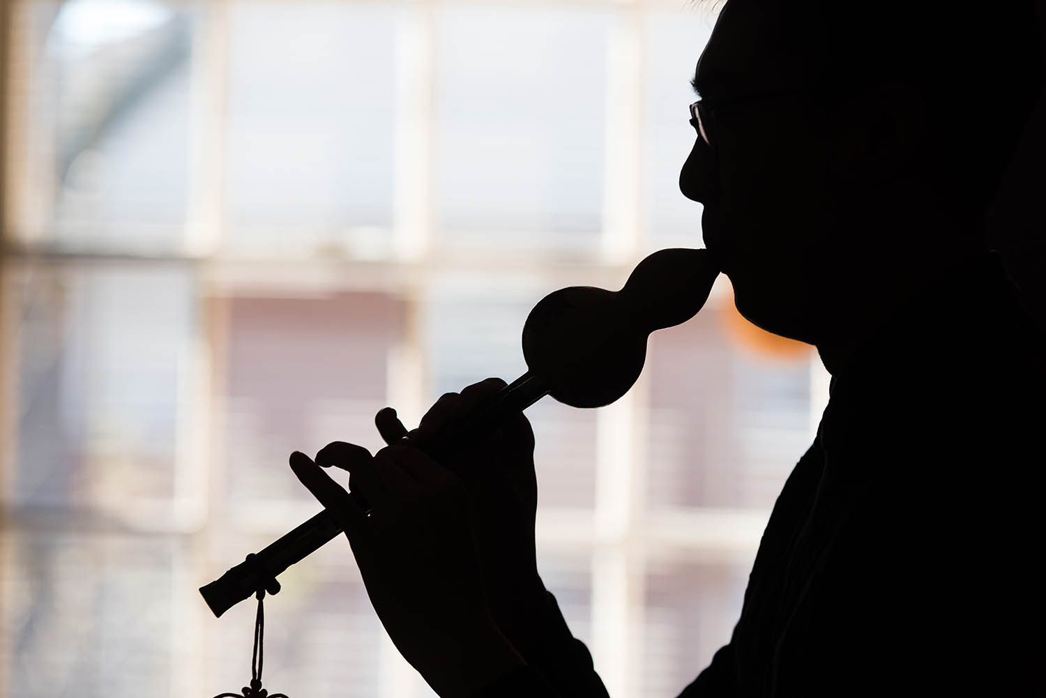 An international student plays a traditional woodwind instrument