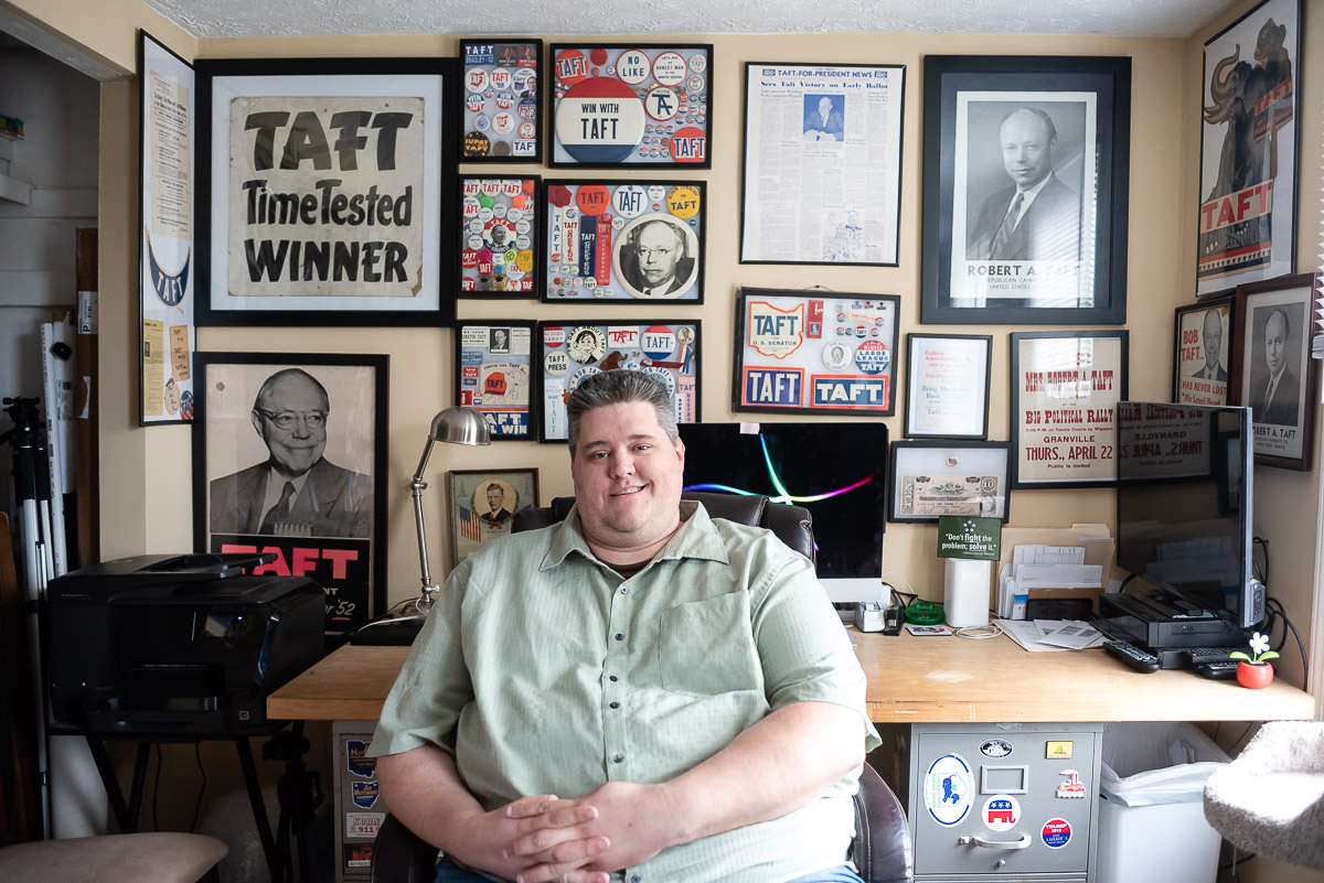 Marietta College Alumni Matt Dole at his desk surrounded by Taft political paraphernalia