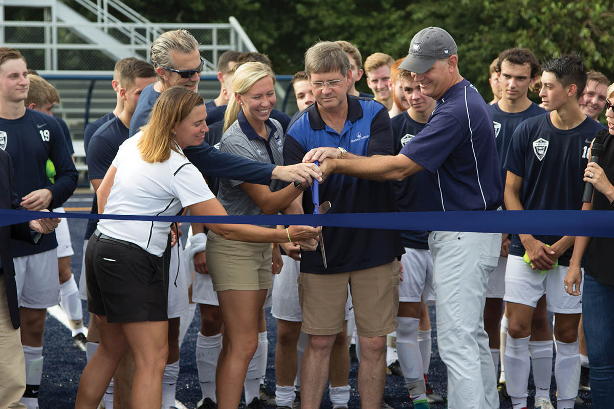 President Ruud cuts the ribbon at the new Soccer Field
