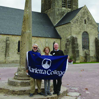 Marietta College Alumni standing in front of the church at Ste. Mere Eglise