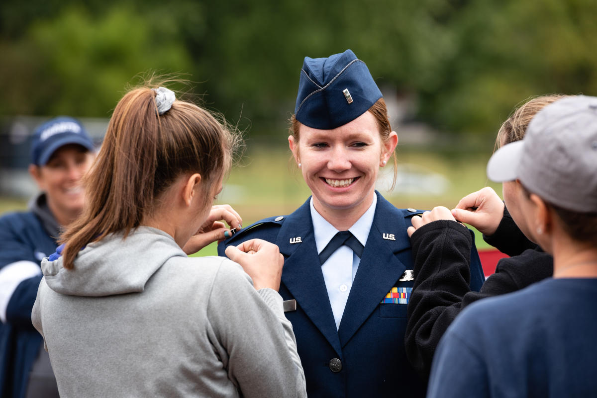 Brittany Curry '15 has her new rank pinned on her during her promotion ceremony on the Marietta Softball Field