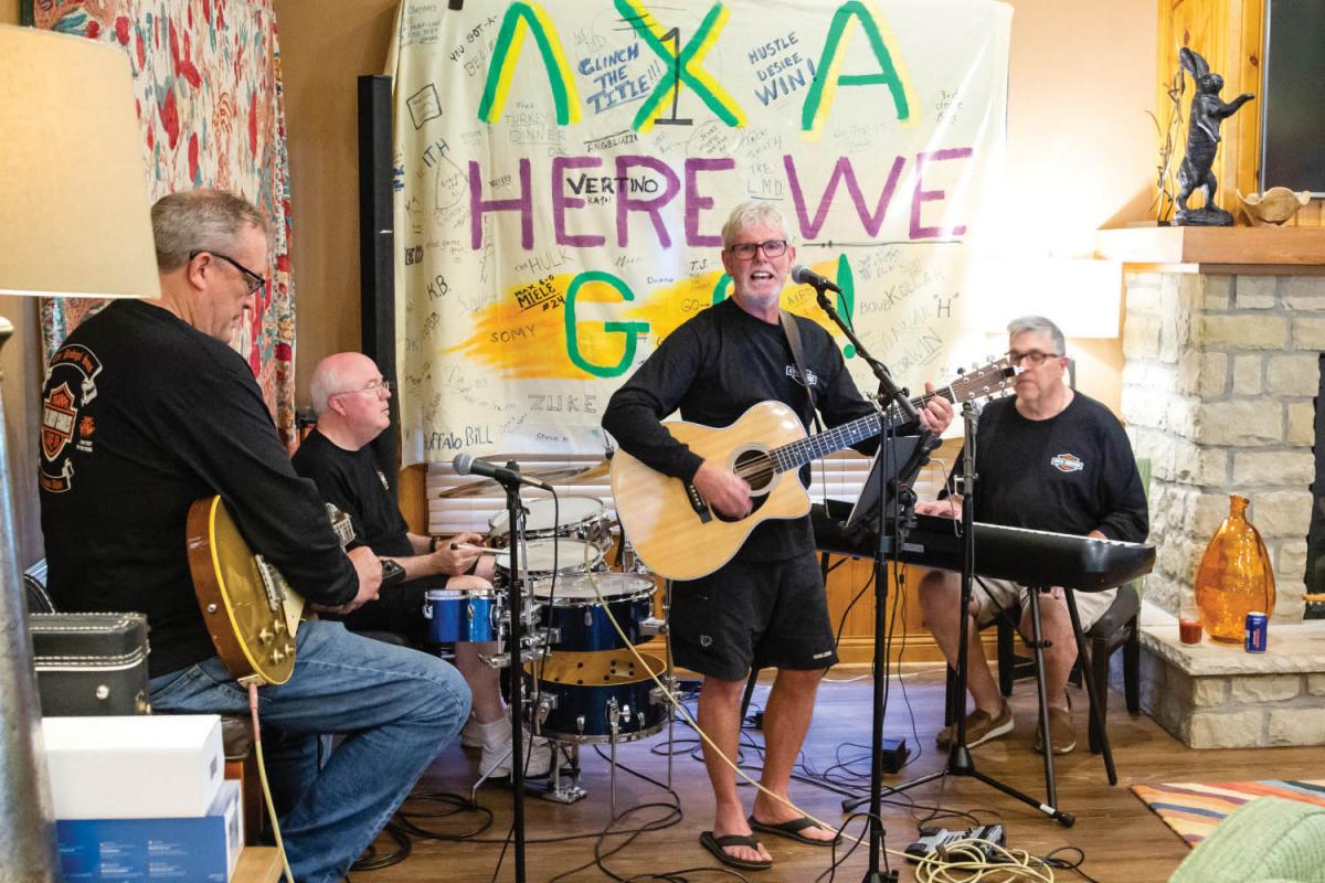  Members of the Lousy Candles Band — Don Ritter ’81, Bruce Kinney ’79, Bill Corwin ’78 and Brian Hennessey ’76 — play a few tunes from the 1970s