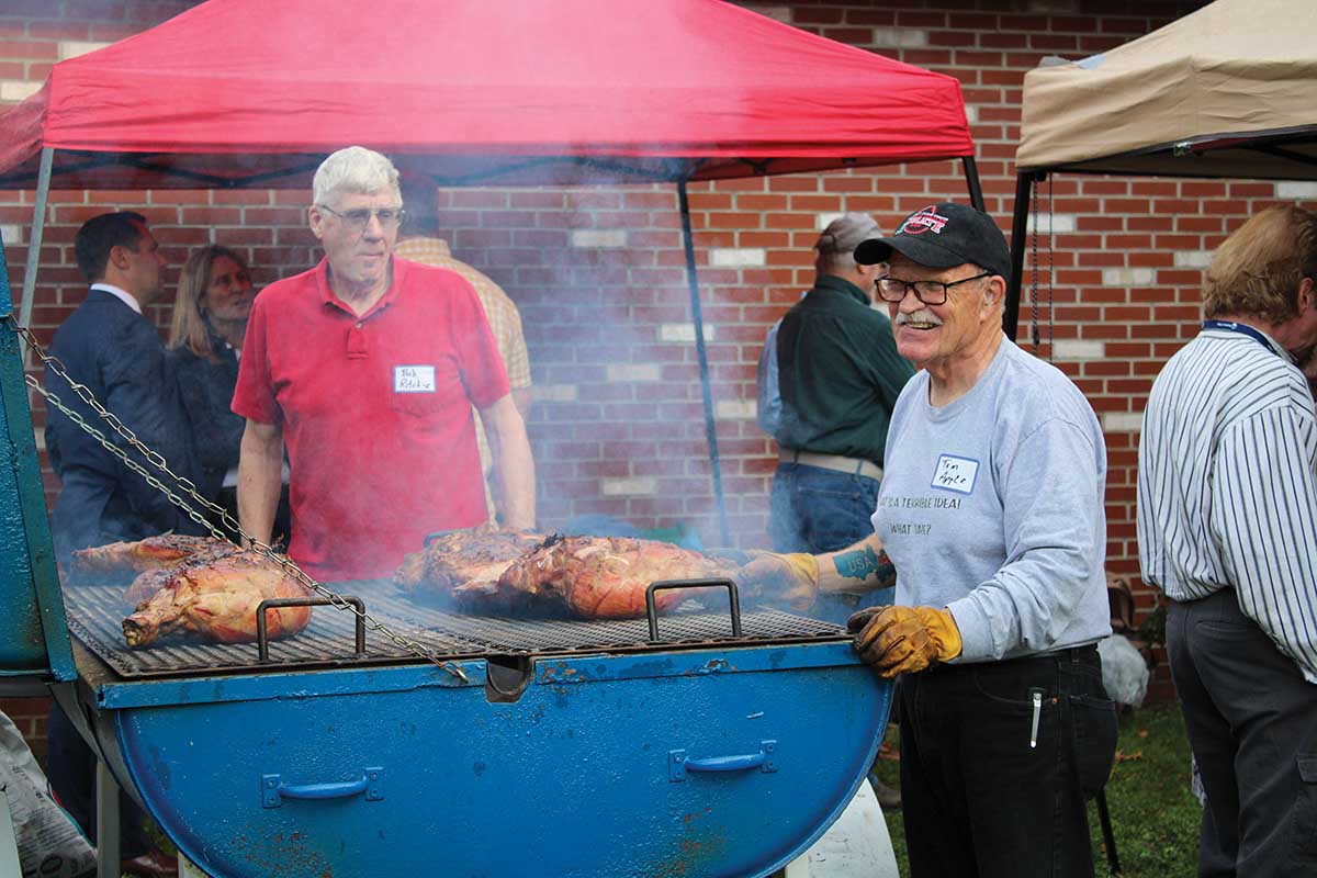 Tom Apple ’68 and Bob Ritchie keep watch over the grill